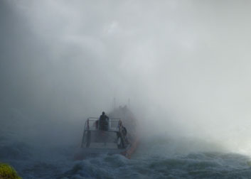 boat disappearing under falls